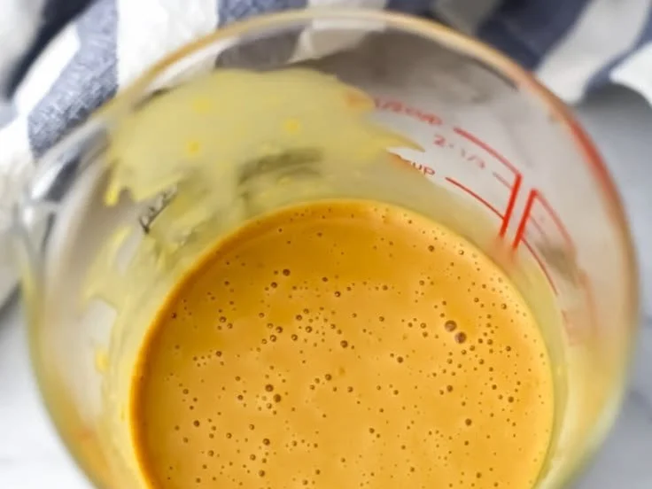 Nutritional Yeast Dressing poured over a fresh salad