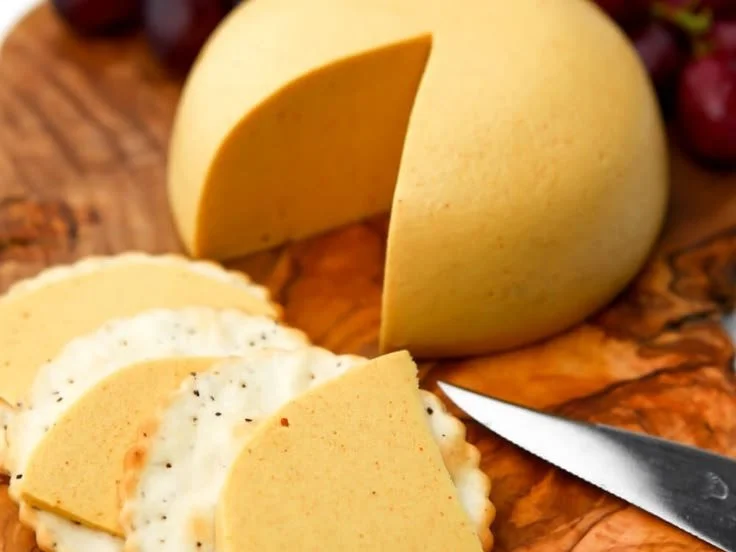 Homemade simple vegan cheddar cheese served on a wooden board