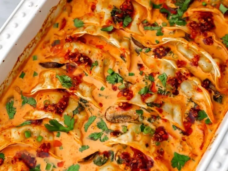 Vegan baked dumplings on a plate, garnished and ready to serve.