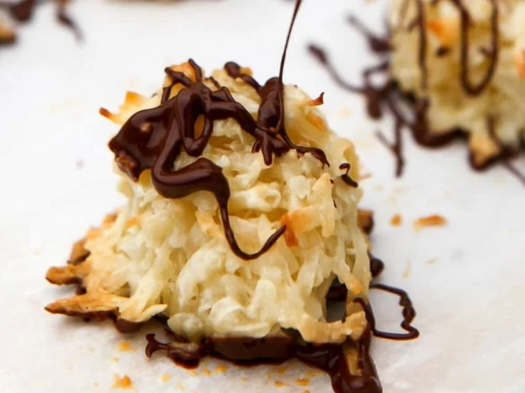 Vegan coconut macaroons stacked on a plate, showcasing a delicious dessert option.