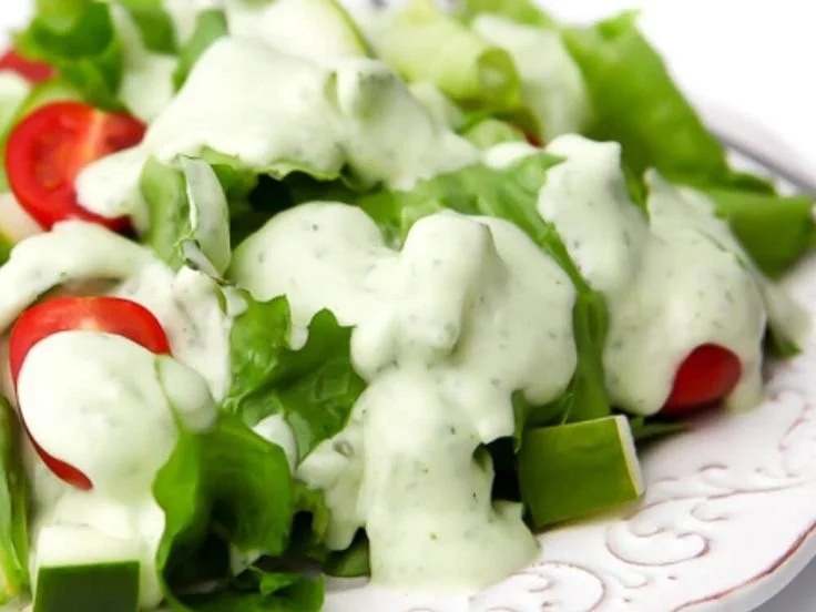 Creamy Vegan Ranch Dressing drizzled over fresh salad greens