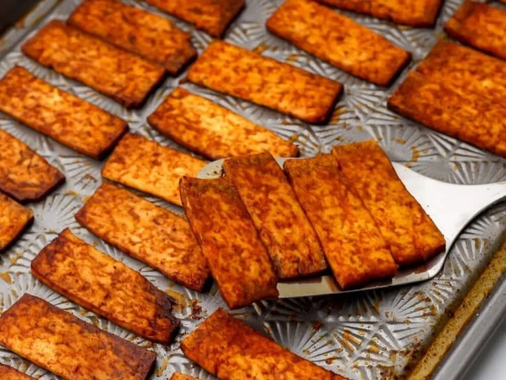 Vegan smoky tofu bacon sliced and ready for cooking
