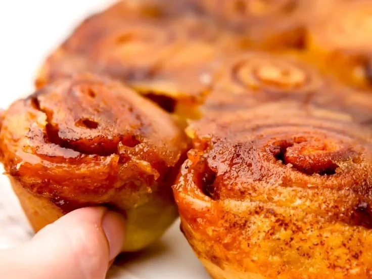 Delicious vegan sticky buns topped with caramel syrup and nuts