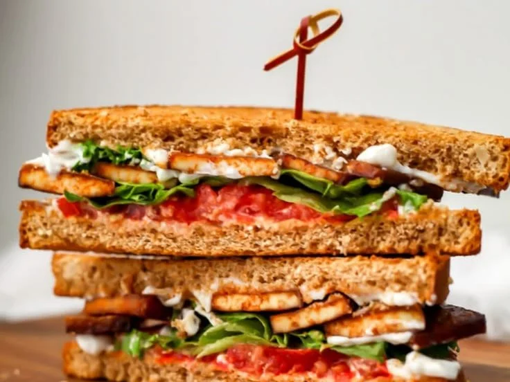 Vegan Tofu BLT sandwich on a plate with fresh ingredients