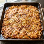 Crispy sheet pan hash browns served on a plate, golden and delicious.
