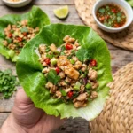 Thai Chicken Lettuce Wraps garnished with fresh herbs and vegetables